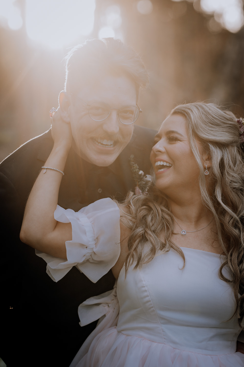 Groom hugging bride from behind at their Mornington Peninsula Wedding